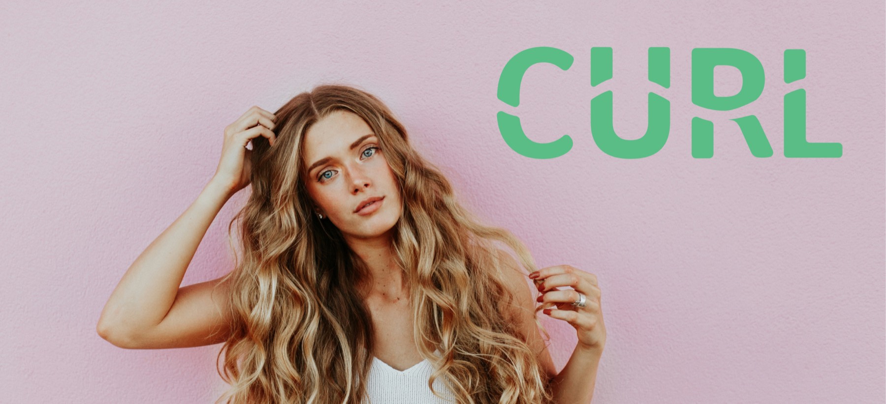 The Curl wordmark in green beside a model with long wavy hair against a pink wall